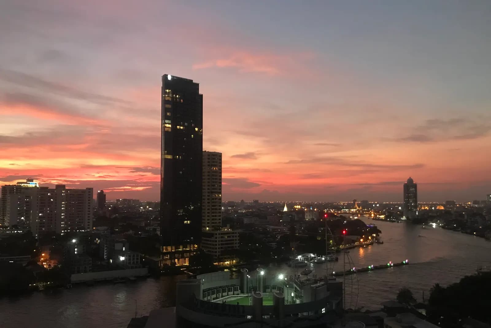 The Chao Phraya River at sunset in early December, seen from Talat Noi, with boats lit up on the water