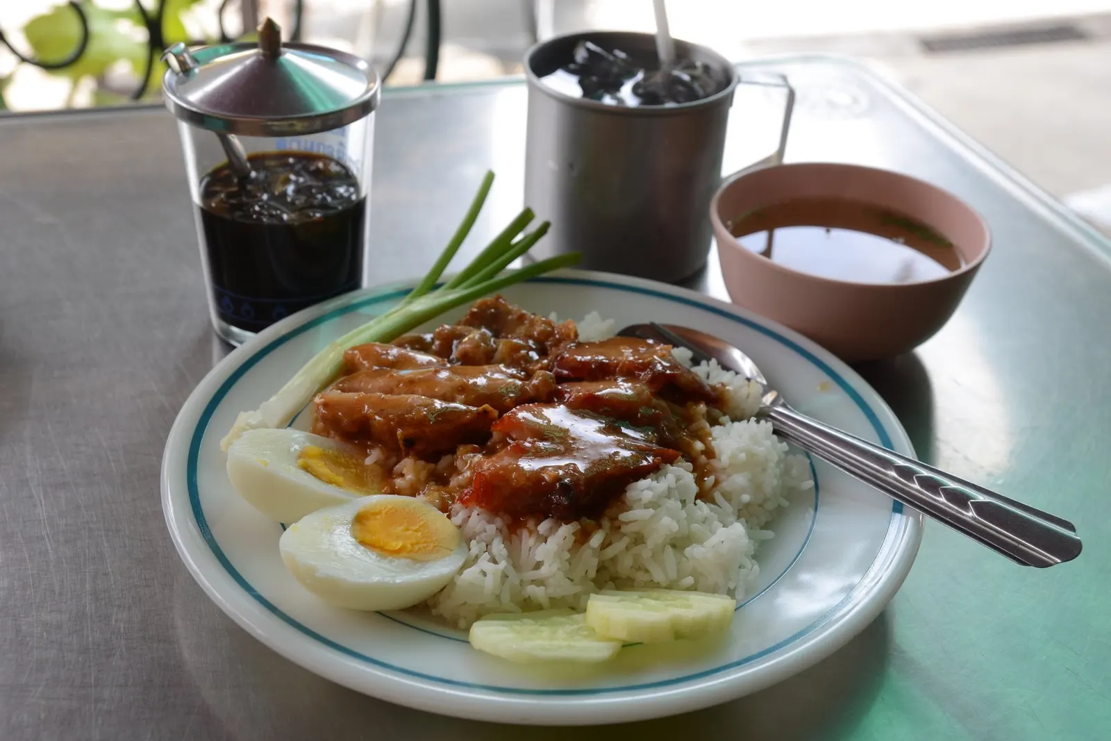 Red pork and crispy pork over rice with sweet red gravy, boiled egg and spring onion