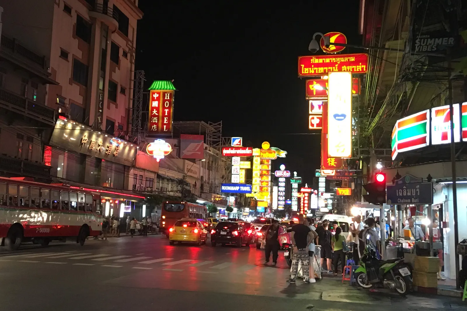 Neon signs and evening traffic on Yaowarat Road in Bangkok's Chinatown