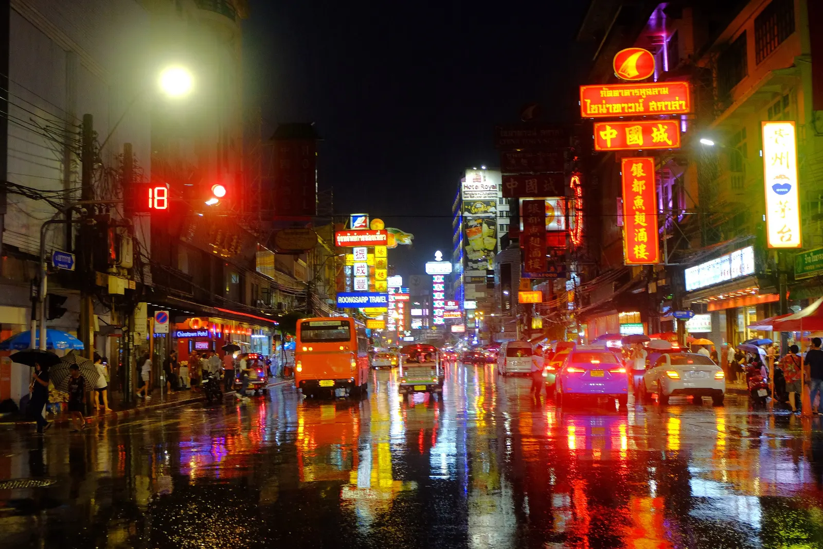 Yaowarat Road after the rain at night, the neon signs reflected on the wet street